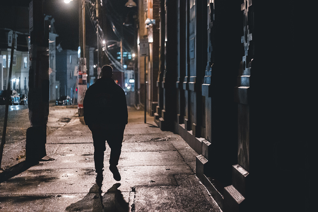 man walking at night